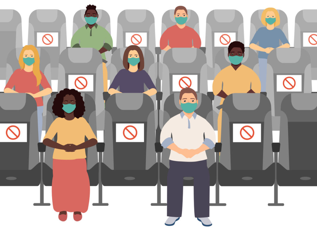A socially distanced audience sitting together at a professional conference.